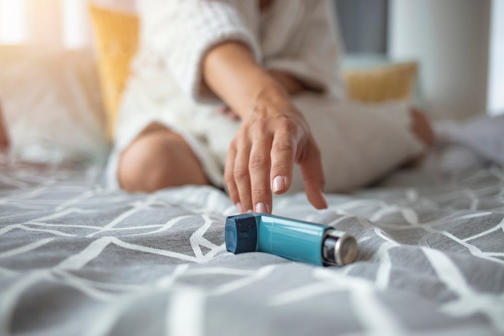 Asthmatic girl reaching for an inhaler